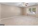 Cozy bedroom with neutral carpet, and a ceiling fan at 105 Birch Creek Cir, Mcdonough, GA 30253