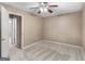 Bright bedroom with fresh neutral paint, soft carpeting, and a ceiling fan for enhanced comfort at 105 Birch Creek Cir, Mcdonough, GA 30253