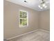 Cozy bedroom featuring a large window, neutral walls, and carpeting, creating a peaceful sanctuary at 105 Birch Creek Cir, Mcdonough, GA 30253