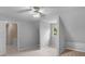 Upstairs bedroom area with attic window and access to hallway at 105 Birch Creek Cir, Mcdonough, GA 30253