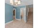 The dining room features tiled flooring, a chandelier, and staircase access enhancing the home's appeal at 105 Birch Creek Cir, Mcdonough, GA 30253