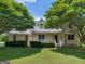 Charming home with a well-manicured lawn and mature trees surrounding the property at 105 Birch Creek Cir, Mcdonough, GA 30253