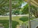 View from the porch of the home, overlooking the spacious front yard and tranquil, tree-lined street at 105 Birch Creek Cir, Mcdonough, GA 30253