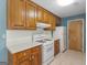 Kitchen featuring white appliances, warm wood cabinets, and ample counter space at 105 Birch Creek Cir, Mcdonough, GA 30253