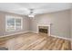 The living room features hardwood floors and a cozy fireplace with ample natural light, perfect for relaxation at 105 Birch Creek Cir, Mcdonough, GA 30253