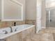 Bathroom featuring a soaking tub, window, and a glass-enclosed shower at 570 Mcgarity Dr, Mcdonough, GA 30252