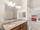 Bathroom featuring a double sink vanity, large mirror, and a view into the main bedroom at 570 Mcgarity Dr, Mcdonough, GA 30252