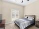 Bedroom featuring a comfortable bed, soft carpet, and a view to the outside at 570 Mcgarity Dr, Mcdonough, GA 30252