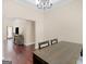 Dining room with hardwood floors, a modern chandelier, and a wooden dining table at 570 Mcgarity Dr, Mcdonough, GA 30252