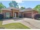 Charming brick home featuring a well-maintained yard, arched entryway, and attached two-car garage at 570 Mcgarity Dr, Mcdonough, GA 30252
