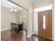 Inviting foyer with dark wood floors, an adjacent dining area, and front door with side-light window at 570 Mcgarity Dr, Mcdonough, GA 30252