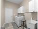 Functional laundry room featuring cabinets, a washer and dryer, and utility sink at 570 Mcgarity Dr, Mcdonough, GA 30252