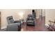 A cozy living room with hardwood flooring, a relaxing recliner, and soft, neutral wall colors at 570 Mcgarity Dr, Mcdonough, GA 30252