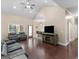 Open living space with hardwood floors, vaulted ceiling, comfortable seating, and access to the backyard at 570 Mcgarity Dr, Mcdonough, GA 30252