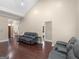 Spacious living room with hardwood floors, high ceilings, and comfortable, leather seating for relaxing and entertaining at 570 Mcgarity Dr, Mcdonough, GA 30252