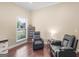 Living room with hardwood floors, featuring two recliners, a side table, and ample natural light at 570 Mcgarity Dr, Mcdonough, GA 30252