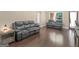 Spacious living room featuring hardwood floors, comfortable sofas, and ample natural light at 570 Mcgarity Dr, Mcdonough, GA 30252