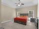 Spacious main bedroom features a tray ceiling, ceiling fan, large windows, and a comfortable king-sized bed at 570 Mcgarity Dr, Mcdonough, GA 30252