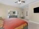 Comfortable main bedroom features a king-sized bed, tv and desk, with an ensuite bathroom at 570 Mcgarity Dr, Mcdonough, GA 30252