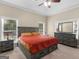 Large main bedroom featuring a king-sized bed, dual nightstands, and a matching dresser with a view of the exterior at 570 Mcgarity Dr, Mcdonough, GA 30252