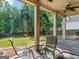 Outdoor patio with ceiling fans, furniture and a view of the landscaped backyard and mature trees at 570 Mcgarity Dr, Mcdonough, GA 30252