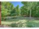 Spacious backyard with green grass, a wooden fence, and mature trees at 857 Cooper Rd, Social Circle, GA 30025