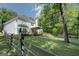 Well-maintained backyard featuring a wooden fence, open green space, and large trees at 857 Cooper Rd, Social Circle, GA 30025