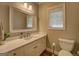 Bathroom with white vanity, mirror, and natural light at 857 Cooper Rd, Social Circle, GA 30025