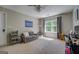 Spacious bedroom with a large window, ceiling fan, and comfortable seating area at 857 Cooper Rd, Social Circle, GA 30025