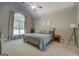Calming bedroom with vaulted ceiling, large windows, and neutral decor at 857 Cooper Rd, Social Circle, GA 30025