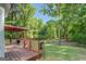 Inviting back deck featuring an outdoor seating area and view of the landscaped yard at 857 Cooper Rd, Social Circle, GA 30025