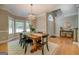 Bright dining room with large windows, modern lighting, and a rustic wooden dining table at 857 Cooper Rd, Social Circle, GA 30025