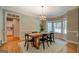 Charming dining room featuring hardwood floors and a farmhouse-style table with black chairs at 857 Cooper Rd, Social Circle, GA 30025