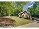 Charming white brick home with black trim and wood shutters with a large yard at 857 Cooper Rd, Social Circle, GA 30025