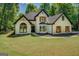 Charming white brick home with black trim and wood shutters at 857 Cooper Rd, Social Circle, GA 30025