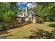 Charming two-story home with a wooden fence, back deck, and lush green lawn at 857 Cooper Rd, Social Circle, GA 30025