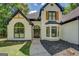Charming white brick home with black trim and wood shutters at 857 Cooper Rd, Social Circle, GA 30025