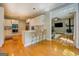 Open concept kitchen and living area with bar seating and wood flooring at 857 Cooper Rd, Social Circle, GA 30025