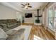 Relaxing living room with wood floors, wood-burning stove, and large television at 857 Cooper Rd, Social Circle, GA 30025