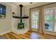 Comfortable living room with wood-burning stove, large windows and wood floors at 857 Cooper Rd, Social Circle, GA 30025