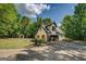 White home with a dark roof, garage, and wooden shutters at 857 Cooper Rd, Social Circle, GA 30025
