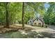 White home with a dark roof, garage, and wooden shutters at 857 Cooper Rd, Social Circle, GA 30025