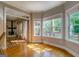 Charming sunroom with beautiful wood floors and large windows offering scenic views at 857 Cooper Rd, Social Circle, GA 30025