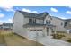 Two-story home showcasing neutral siding and brick accents, complete with an attached two-car garage at 1841 N Lacebark Elm Way # 101, Lawrenceville, GA 30045