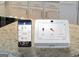 Smart home security system display showing system status and thermostat controls on a kitchen counter at 1841 N Lacebark Elm Way # 101, Lawrenceville, GA 30045