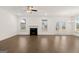 Open living room boasts hardwood floors, fireplace, windows, and access to the outdoor patio at 1841 N Lacebark Elm Way # 101, Lawrenceville, GA 30045