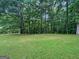 Lush green grass in the backyard provides a serene and inviting outdoor space at 715 Frog Rd, Locust Grove, GA 30248