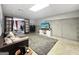 Finished basement featuring a large area rug, comfortable seating, and stylish glass paneled doors at 715 Frog Rd, Locust Grove, GA 30248