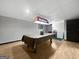 Finished basement with an antique pool table, hardwood flooring, and Budweiser light at 715 Frog Rd, Locust Grove, GA 30248