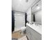 Neutral bathroom featuring a shower and tub combination, light gray vanity and a decorative mirror at 715 Frog Rd, Locust Grove, GA 30248